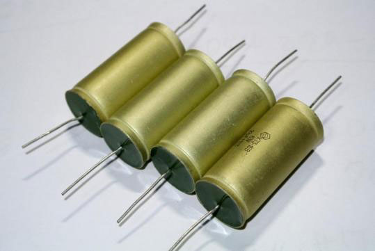 How do I check a capacitor with a multimeter?