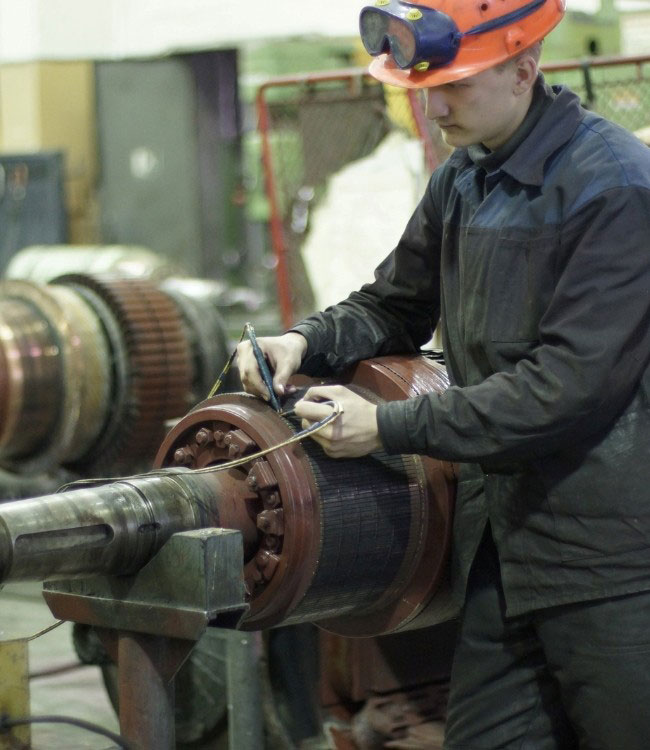 Electrician checks integrity of electric motor windings. 