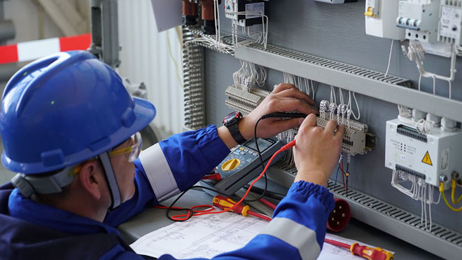 Electrical engineer checks and adjusts electrical circuits. 