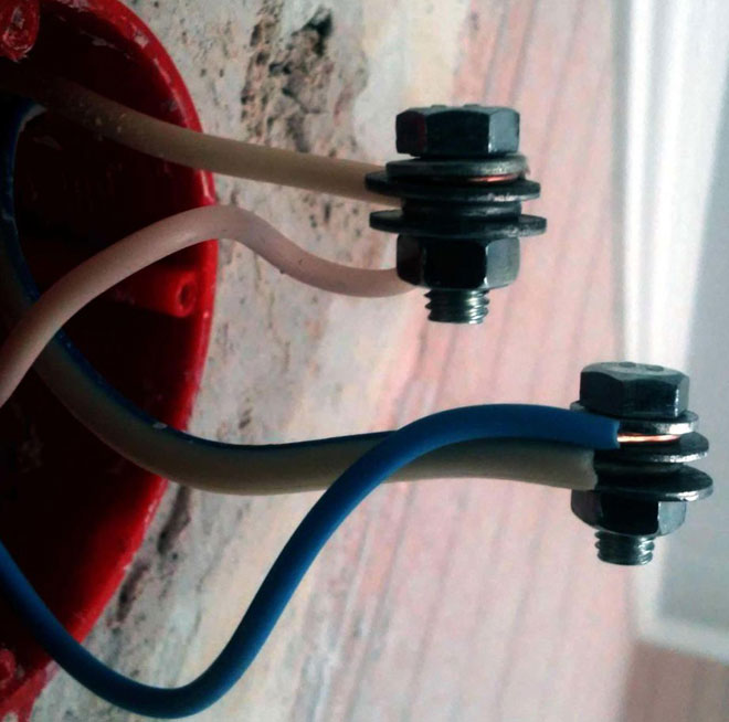 Connecting wires with a bolt, washers, and nut. 