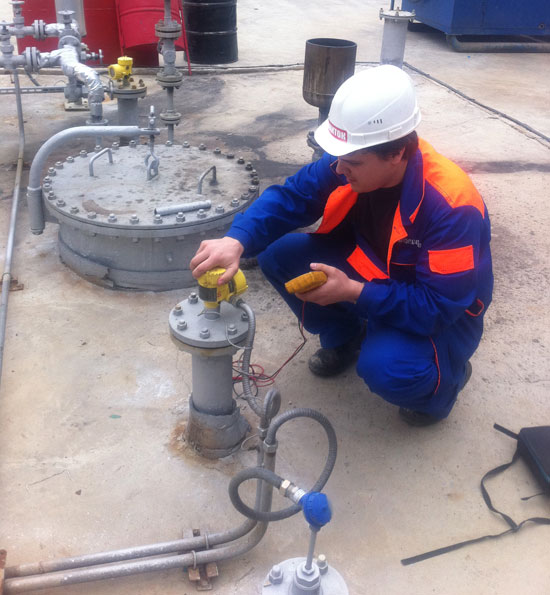 The instrumentation engineer checks the level sensor settings. 
